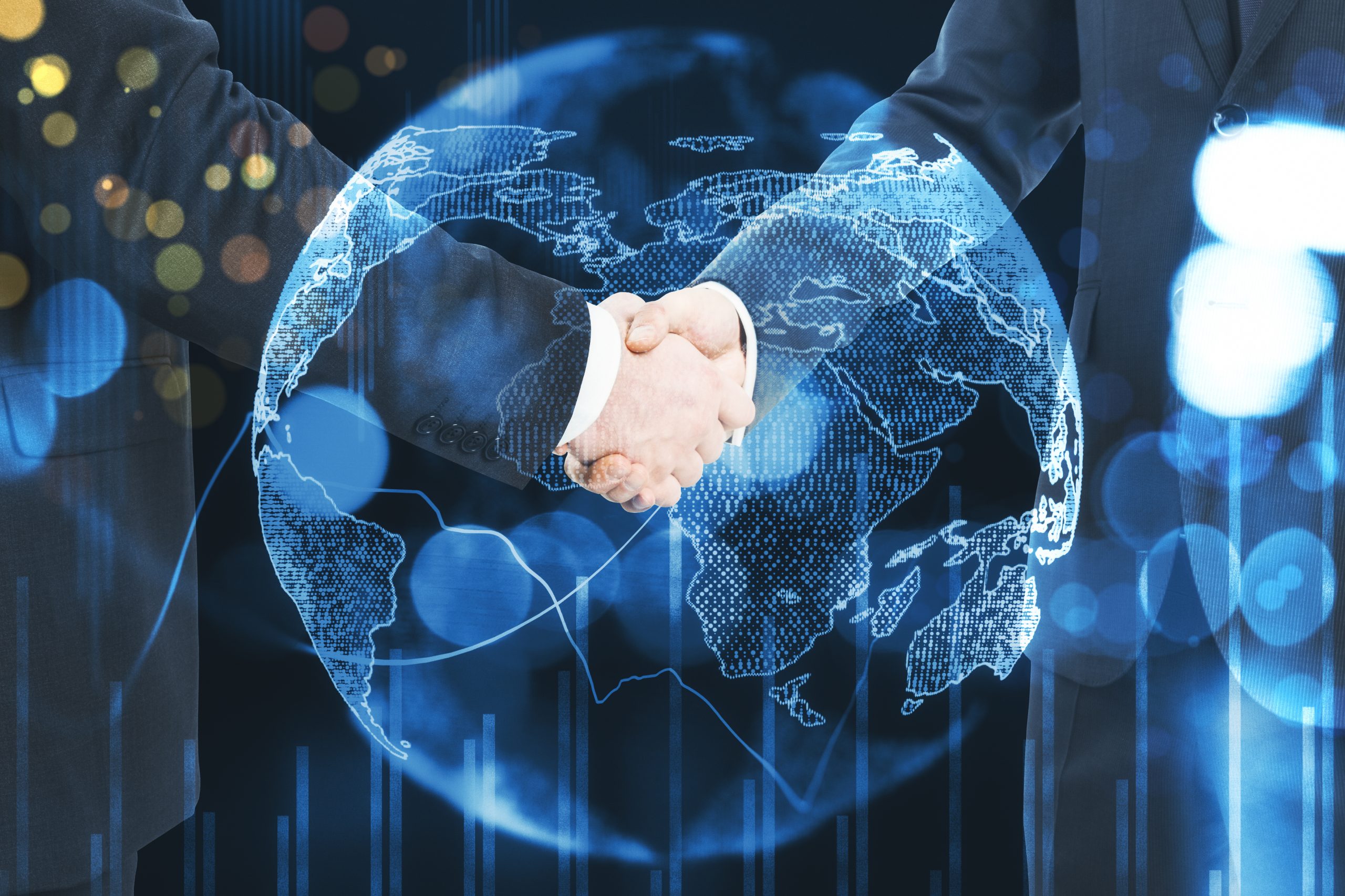 Two businesspeople shake hands over a glowing digital world map, signaling a global partnership.