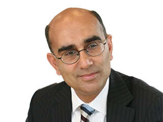 Portrait of a middle-aged man wearing glasses and a dark pinstripe suit, looking to the left.